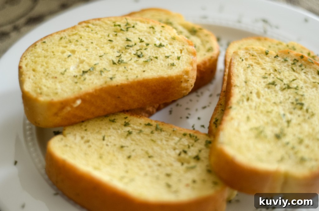 Close-up of perfectly cooked Air Fryer Texas Toast, golden and buttered, ready to eat.