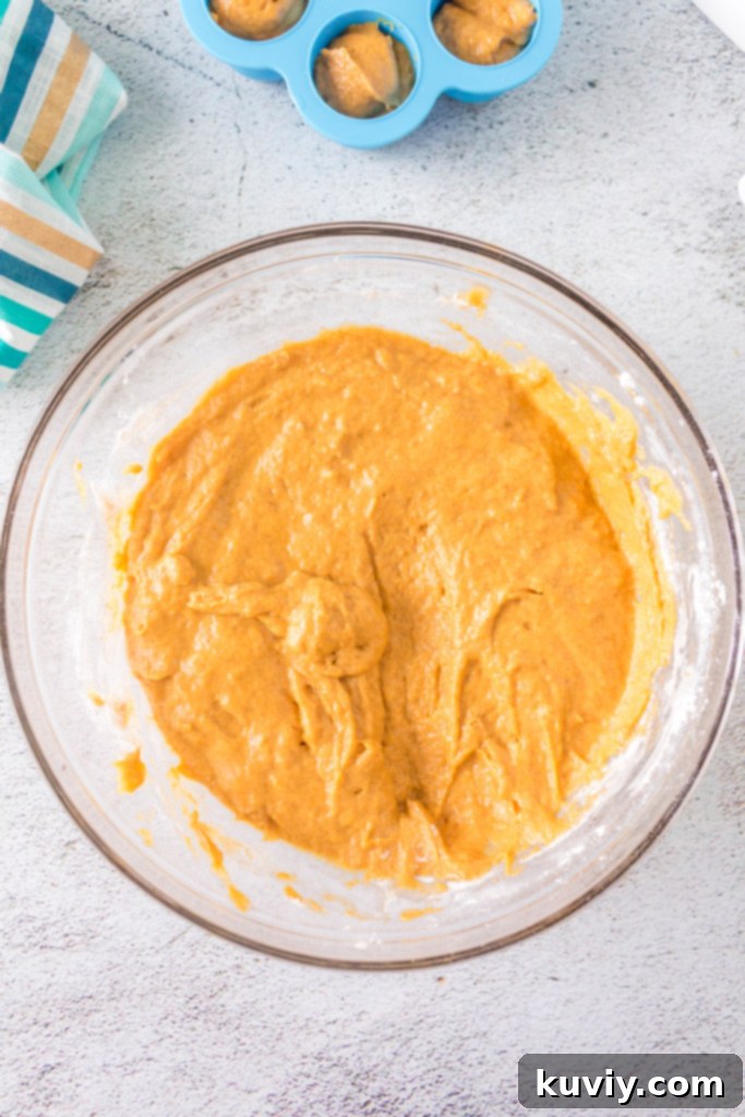 Air fryer pumpkin doughnut holes cooling on a rack after being cooked.