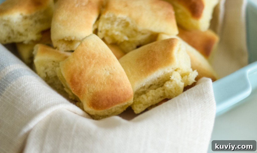 Effortless Air Fryer Dinner Rolls 5 Buttery, golden air fryer dinner rolls on a serving platter.