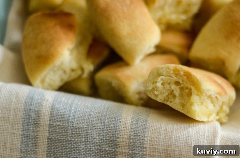 Effortless Air Fryer Dinner Rolls 6 Close-up of golden brown air fryer dinner rolls, brushed with butter.
