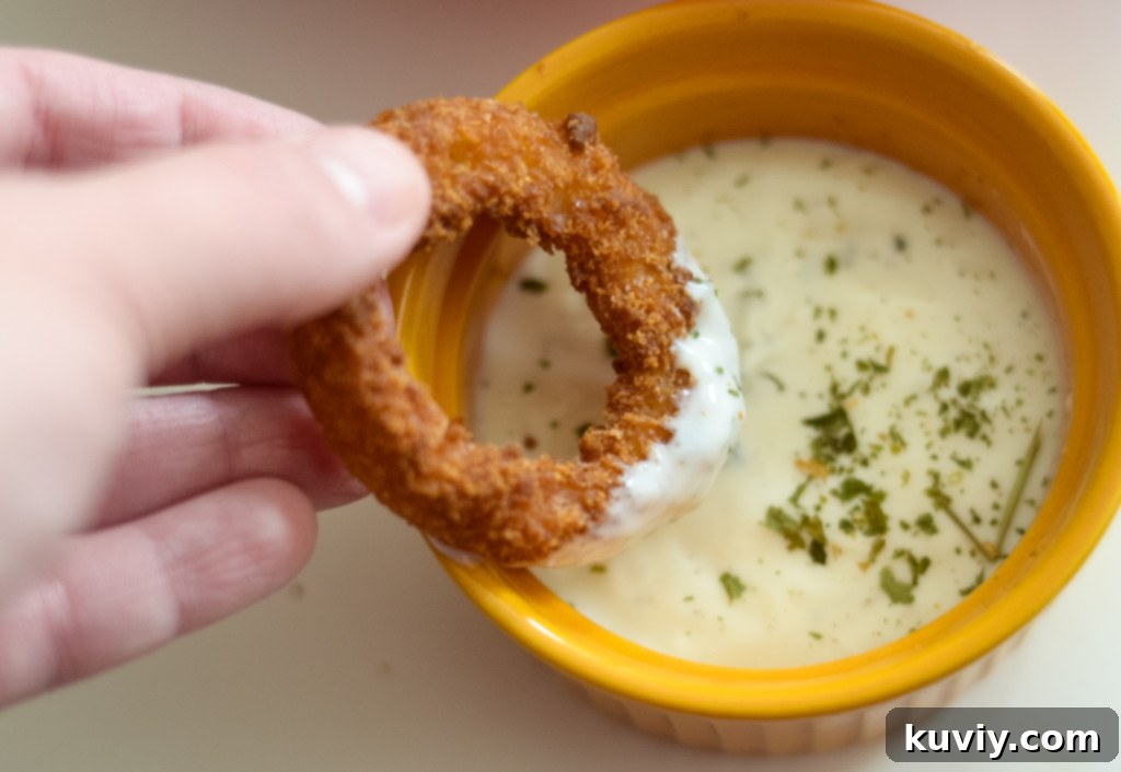 Air fryer in action, cooking frozen onion rings