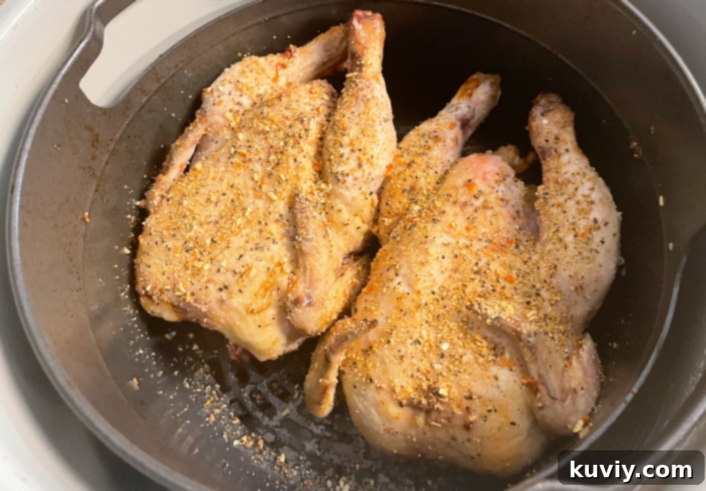 air fryer cornish hens being flipped in air fryer