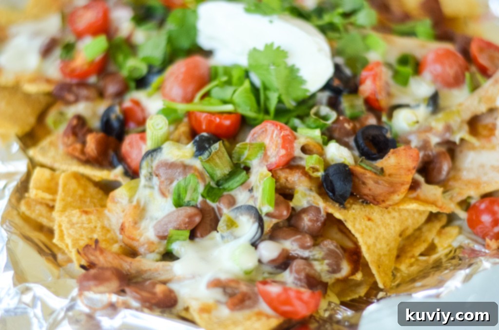 Crispy Air Fryer Nachos 7 Stacked air fryer nachos ready to be eaten