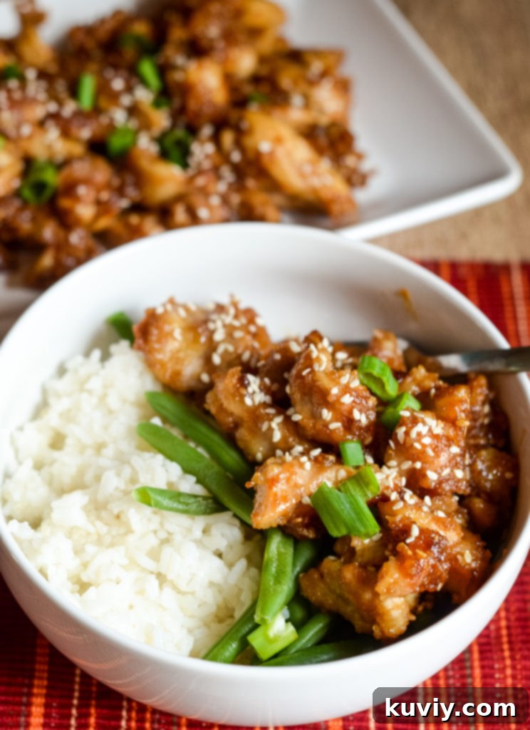 Crispy Air Fryer Sesame Chicken coated in sticky sweet sauce, served over rice