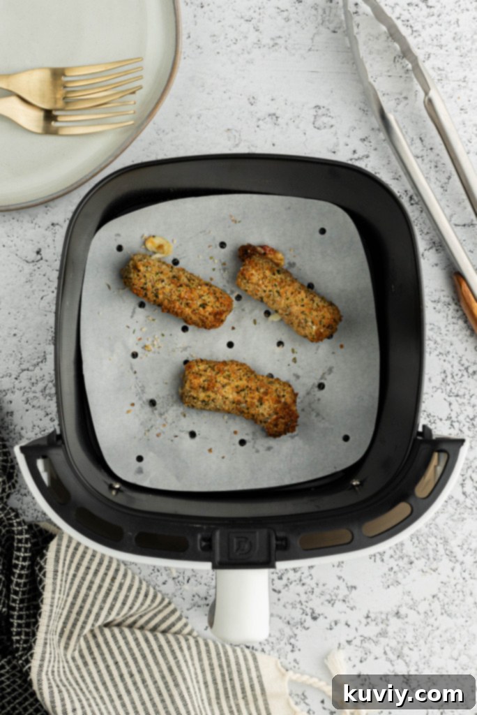 Air fryer basket soaking in soapy water