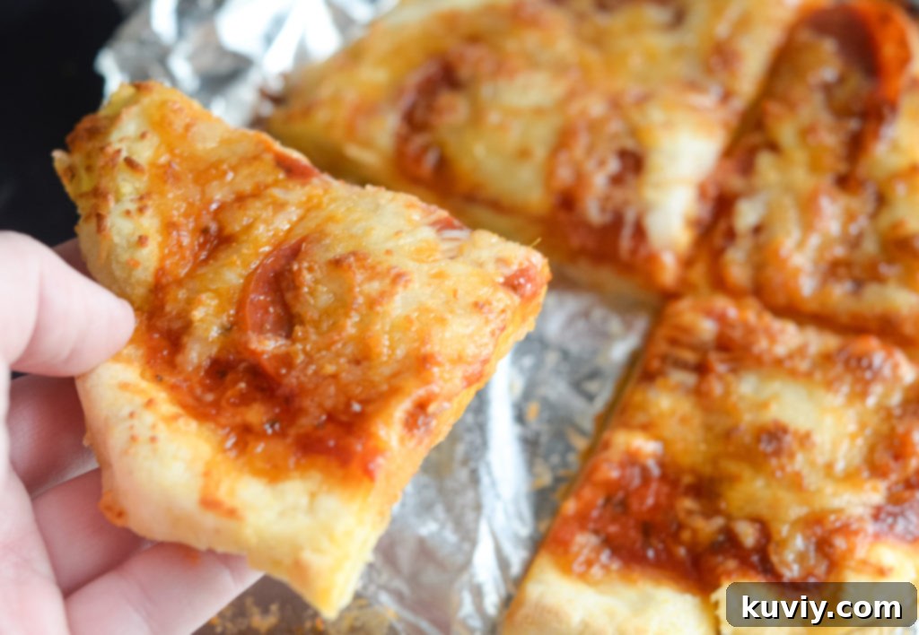 Crispy Gluten-Free Air Fryer Pizzas 6 Two freshly cooked Air Fryer Pan Pizzas on a cutting board, garnished with fresh basil.