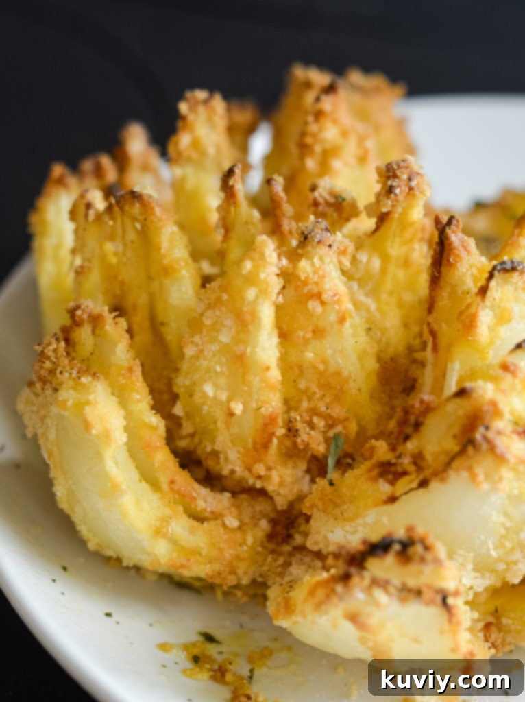 Crispy air fried blooming onion, perfectly golden brown and ready to eat.
