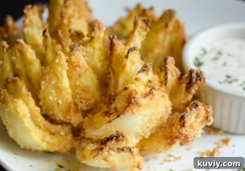 Air fried blooming onion being cooked in an air fryer basket.