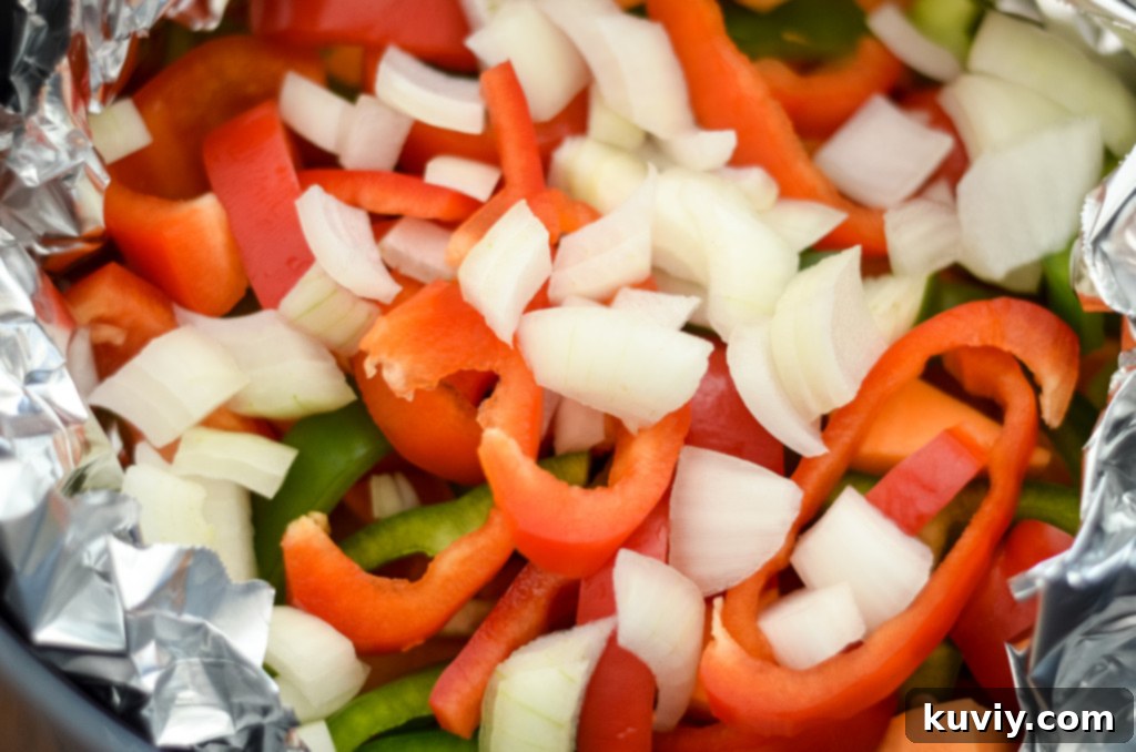 Crispy Air Fryer Sweet Potato Hash 3 fresh ingredients for air fryer sweet potato hash, including diced sweet potatoes, bell peppers, and onion