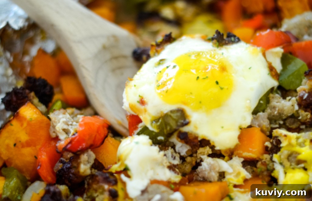 Crispy Air Fryer Sweet Potato Hash 7 air fryer sweet potato hash with an egg on top, ready to serve