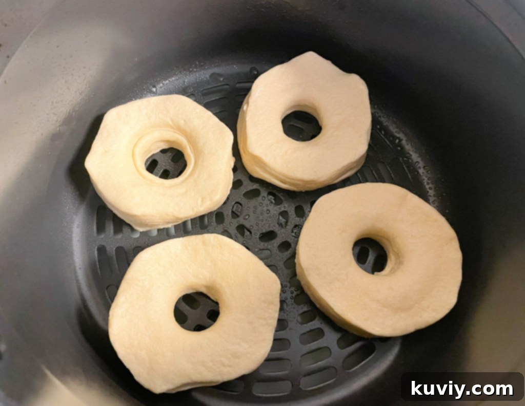cutting the center out of canned biscuits to form air fryer donuts