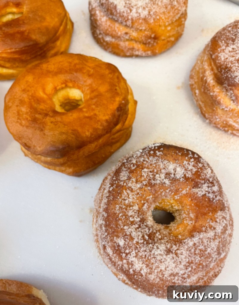 brushing melted butter onto an air fryer donut