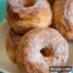 Air Fryer Cinnamon Sugar Donuts with a bite taken out, showing the flaky texture