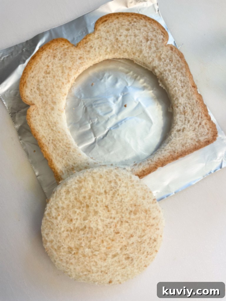 Sliced bread with a hole cut out, ready for an egg in the air fryer.