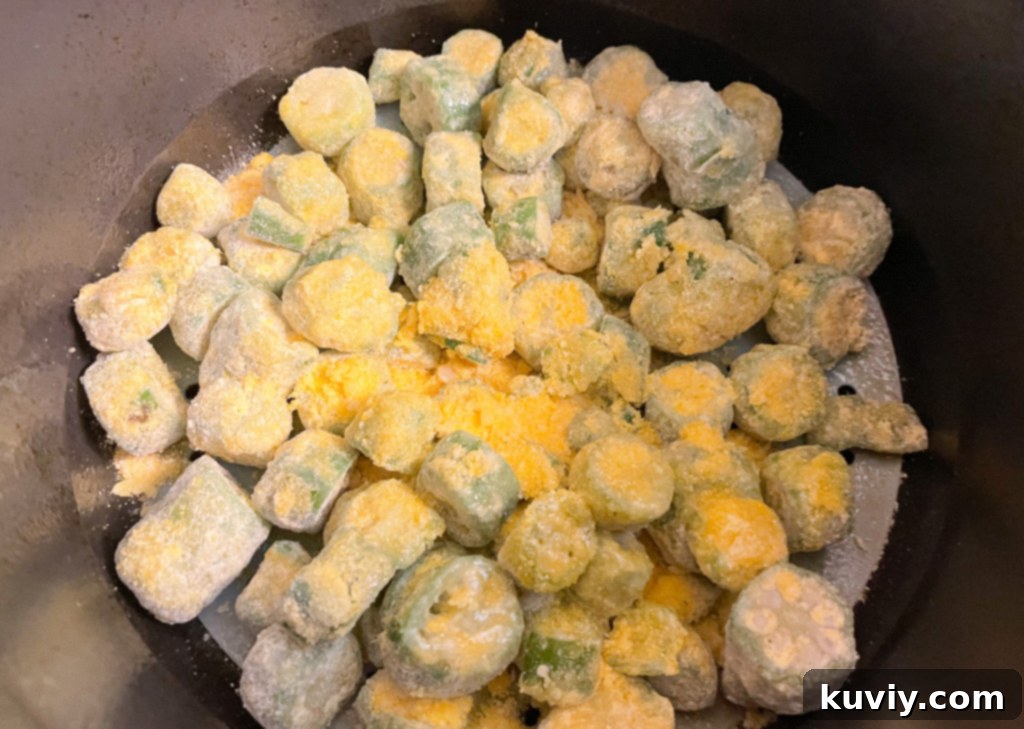 Air fried okra cooking in an air fryer basket