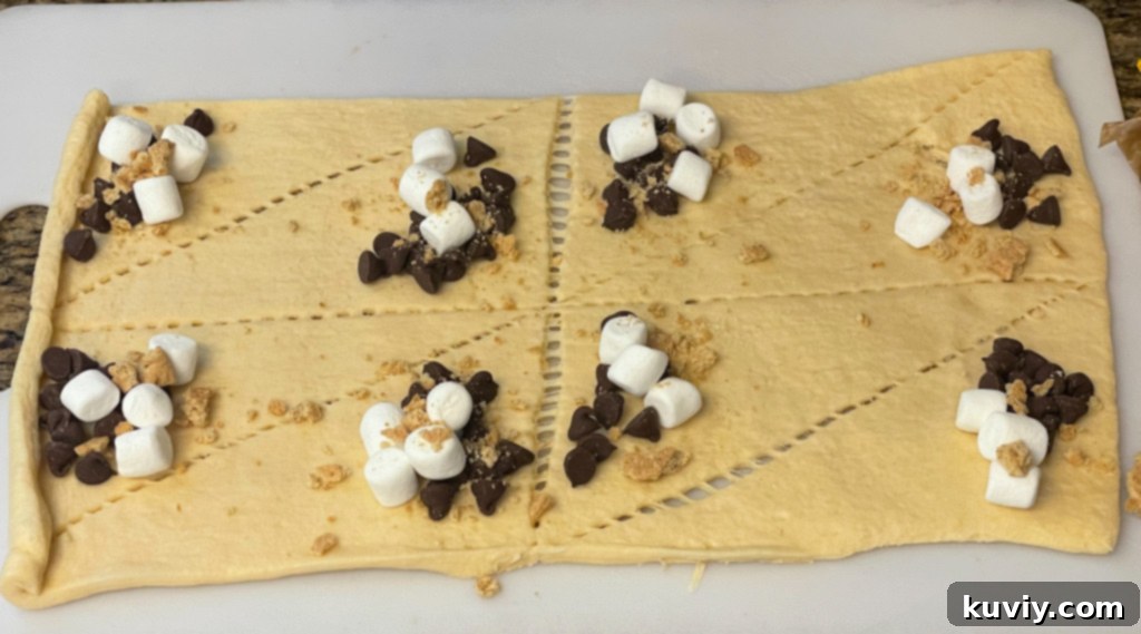 S'mores ingredients being added to crescent roll dough.