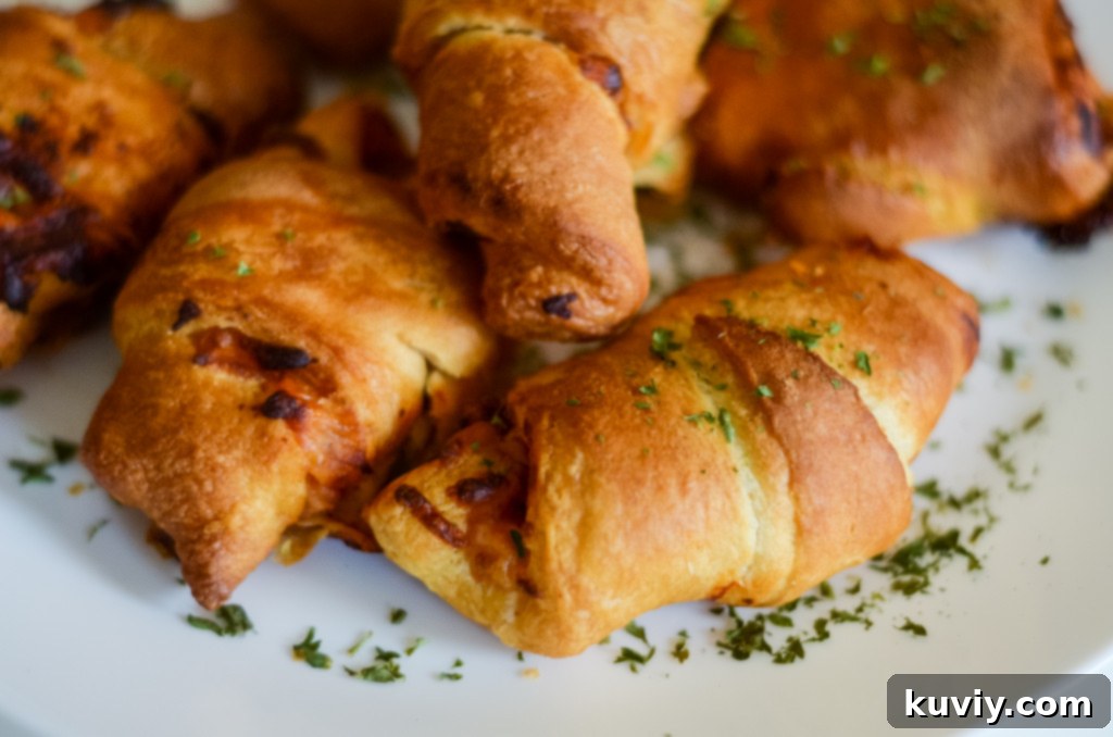 Air fryer basket filled with pizza crescent rolls