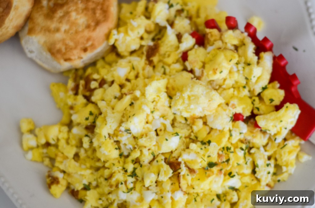 air fryer scrambled eggs being stirred with a meat chopper