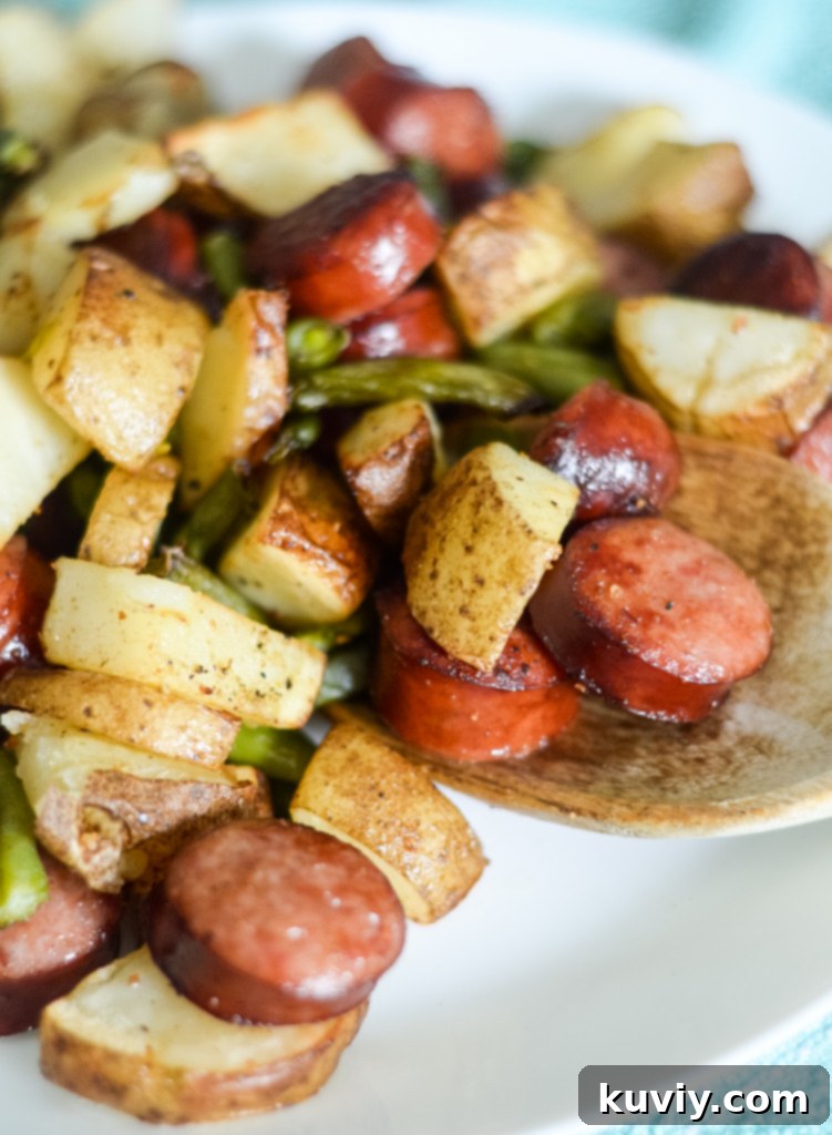 Crispy Air Fryer Kielbasa with golden brown potatoes and vibrant green beans, served as a complete one-dish meal