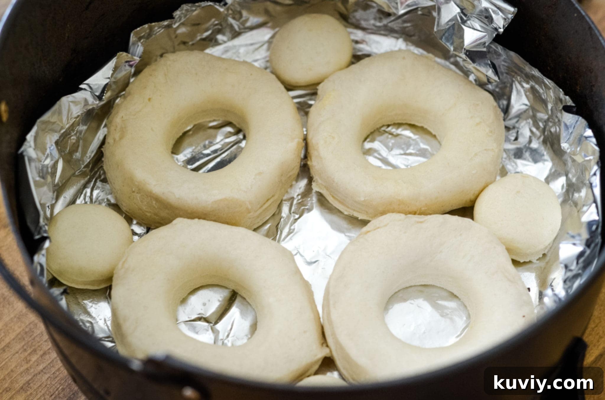 Ingredients for air fryer donuts including canned biscuits, powdered sugar, vanilla, and sprinkles