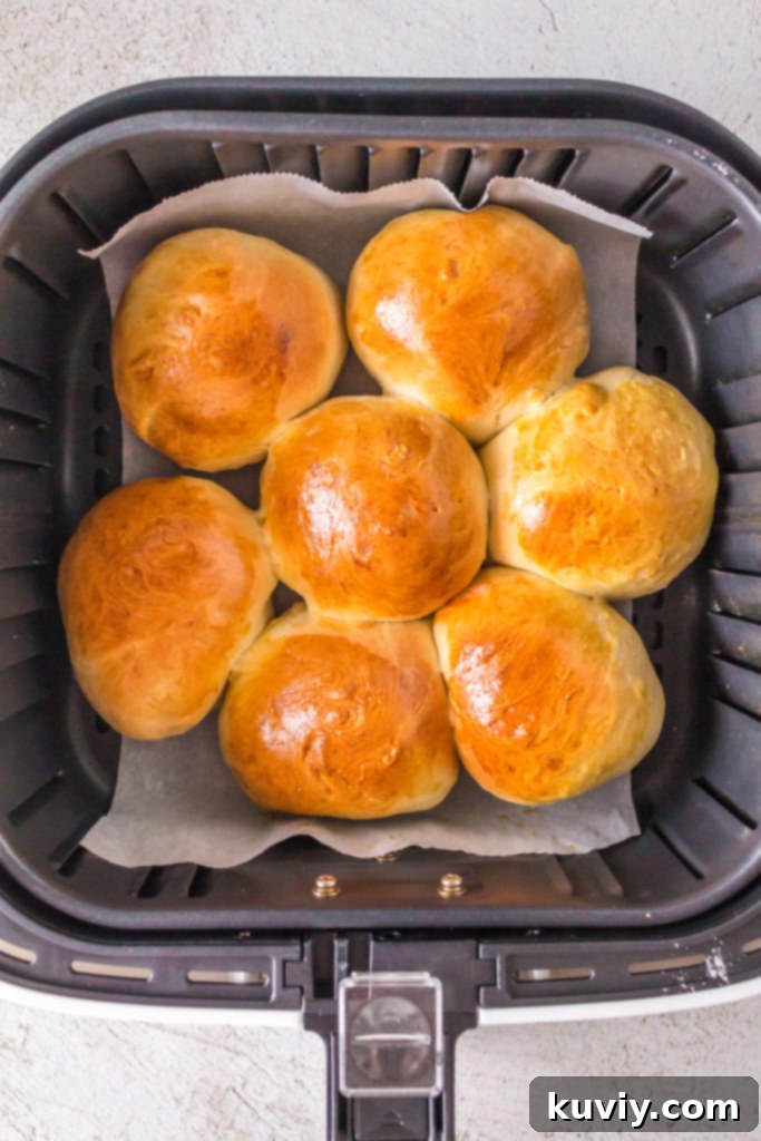 Freshly baked air fryer dinner rolls from scratch cooling on a rack