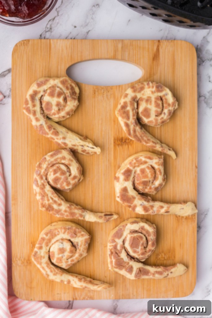Sweetheart Air Fryer Cinnamon Rolls 4 Partially unrolled cinnamon roll for heart shape