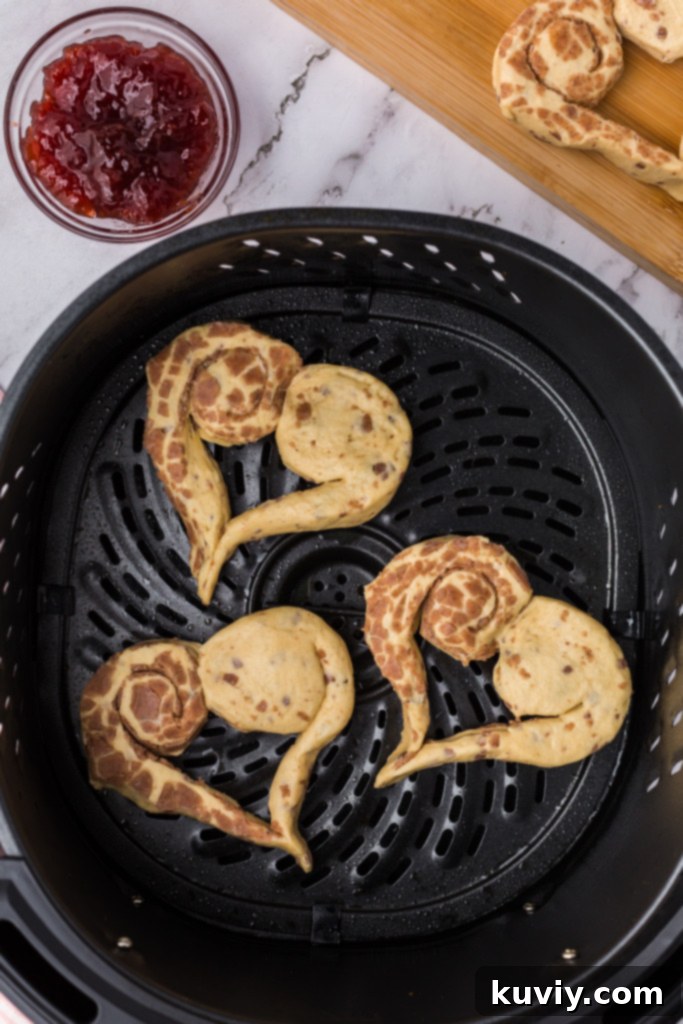 Sweetheart Air Fryer Cinnamon Rolls 6 Heart-shaped cinnamon rolls in air fryer basket