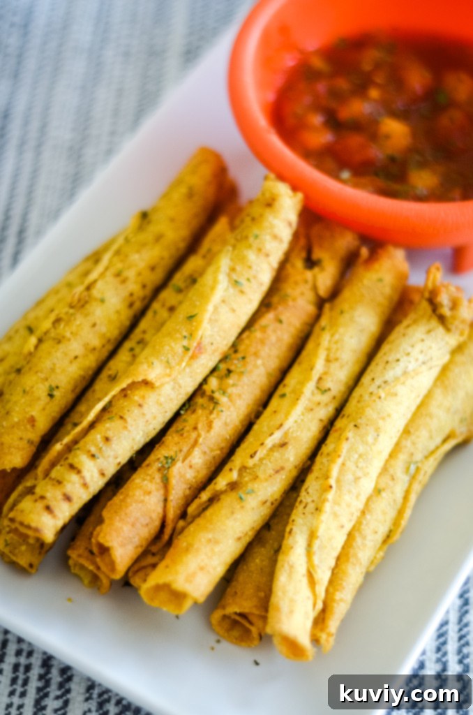 Crispy air fryer frozen taquitos arranged for serving