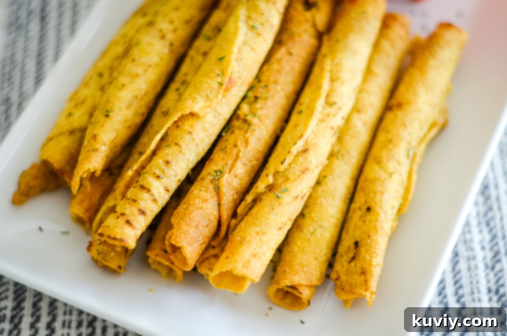 Close-up of golden brown air fried frozen taquitos