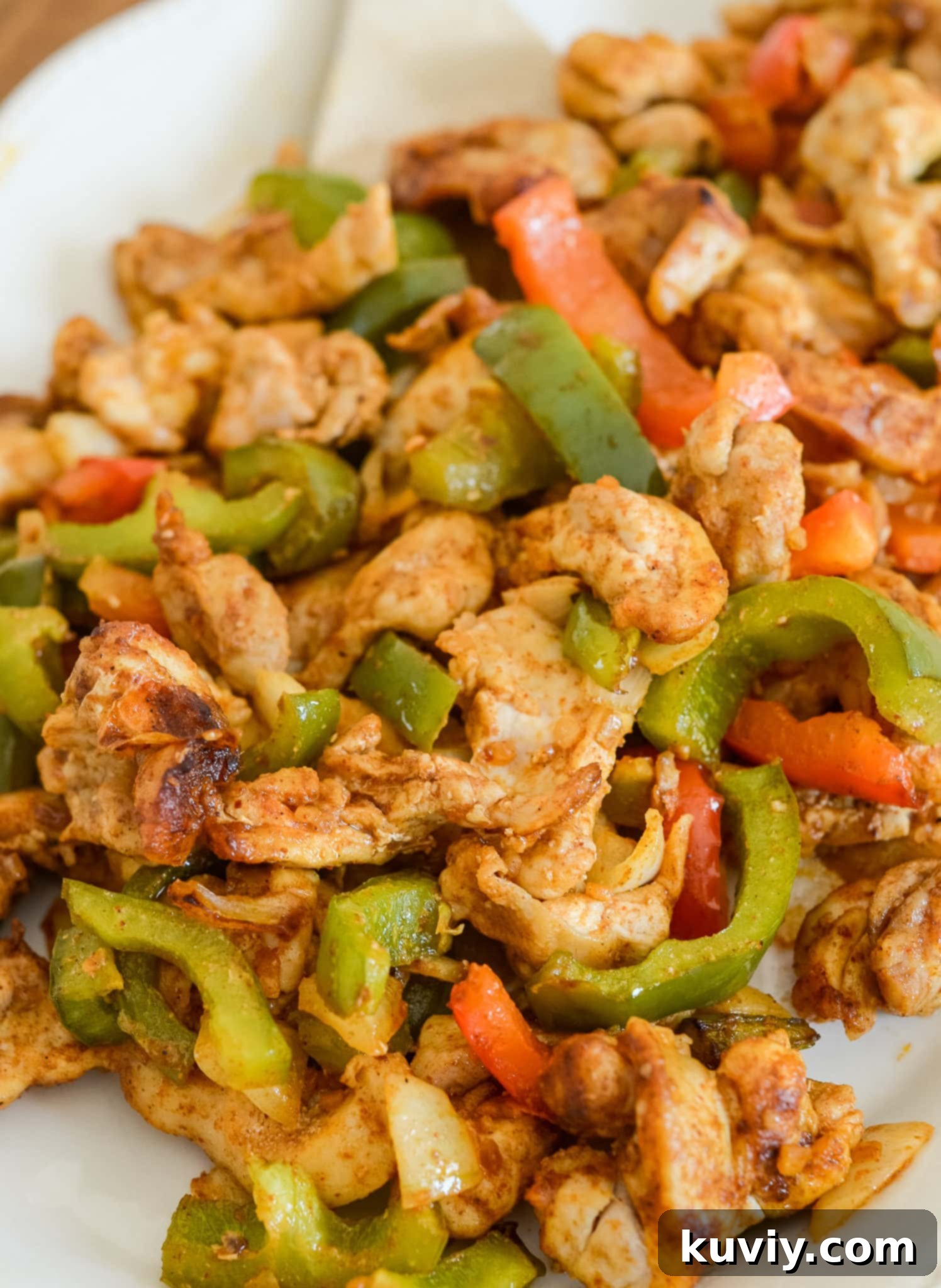 Air Fryer Chicken Fajitas on a plate with warm tortillas and fresh toppings.