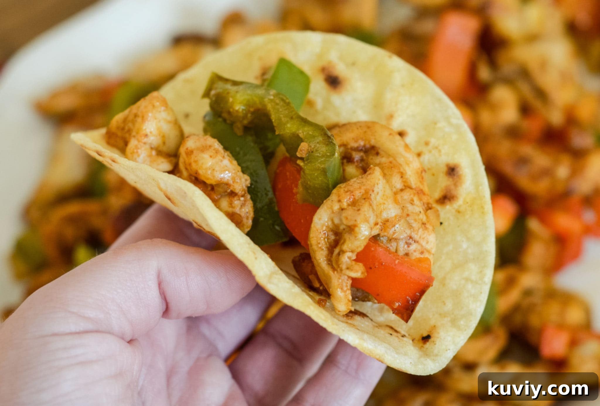 Various warm tortillas arranged on a serving plate, ready for fajitas.