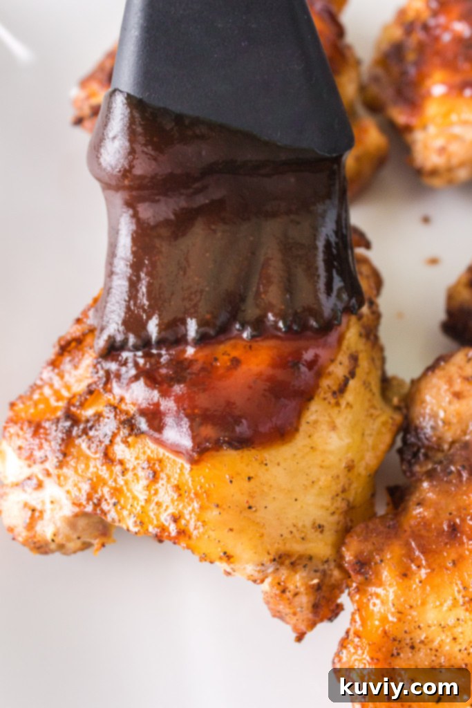 Air Fryer BBQ Chicken Thighs in a lined air fryer basket