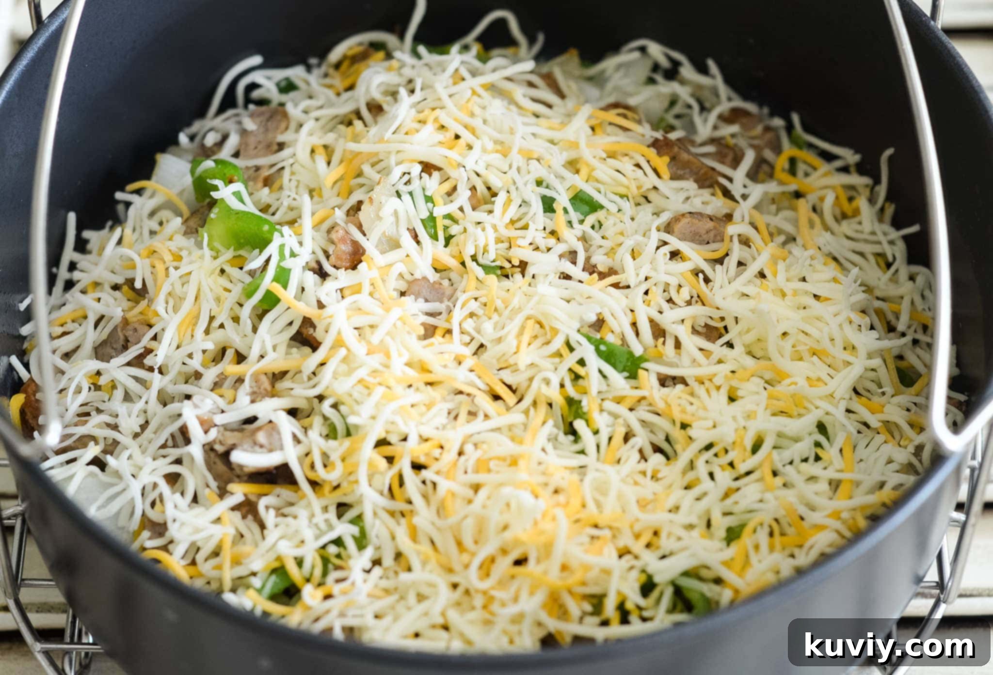 Fresh ingredients for Air Fryer Low-Carb Breakfast Casserole including sausage, eggs, cheese, onion, and bell pepper