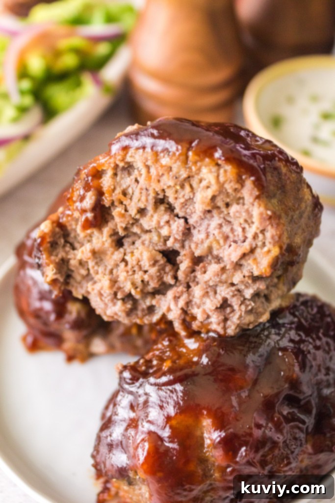 Perfectly cooked air fryer mini meatloaf ready to be served, topped with barbecue sauce.