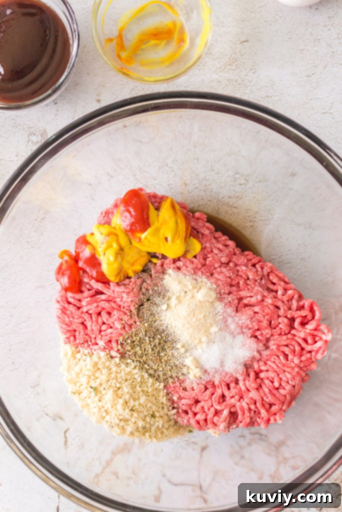 Close-up of a mini meatloaf patty, showcasing the ground beef mixture with breadcrumbs and seasonings.