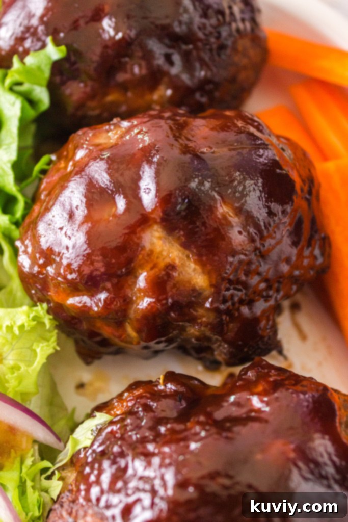 A Ninja Foodi multi-cooker with the lid open, showing mini meatloaves inside the basket.