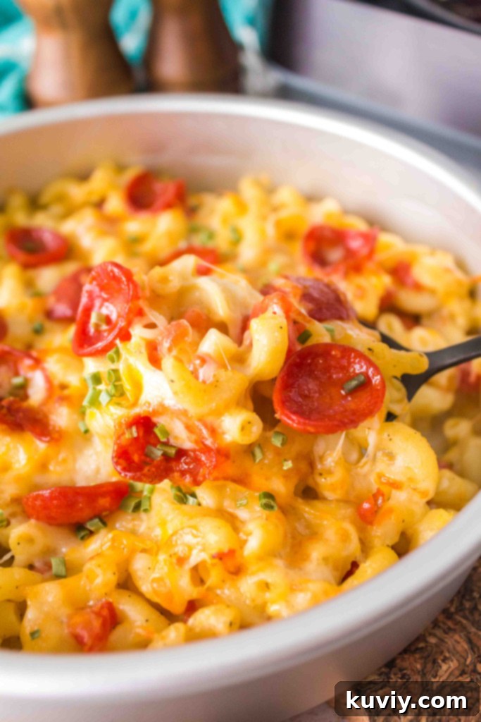 Hand scooping Air Fryer Pizza Pasta with a spatula