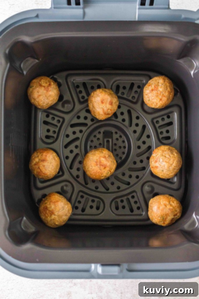 Air fryer basket filled with perfectly cooked, golden-brown turkey meatballs