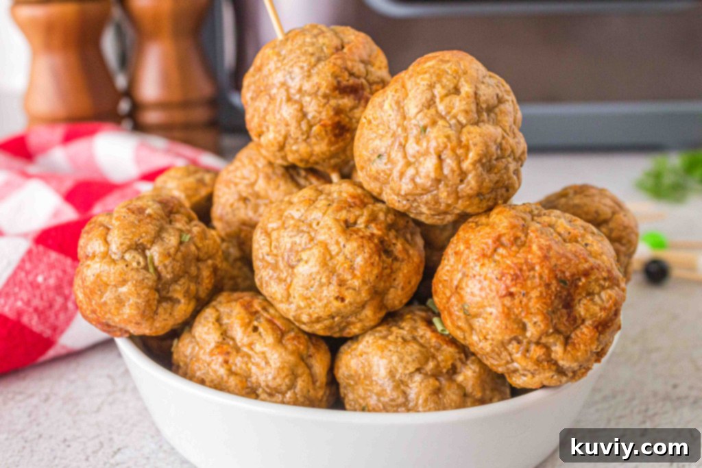 Close-up of a perfectly formed raw turkey meatball, ready for the air fryer