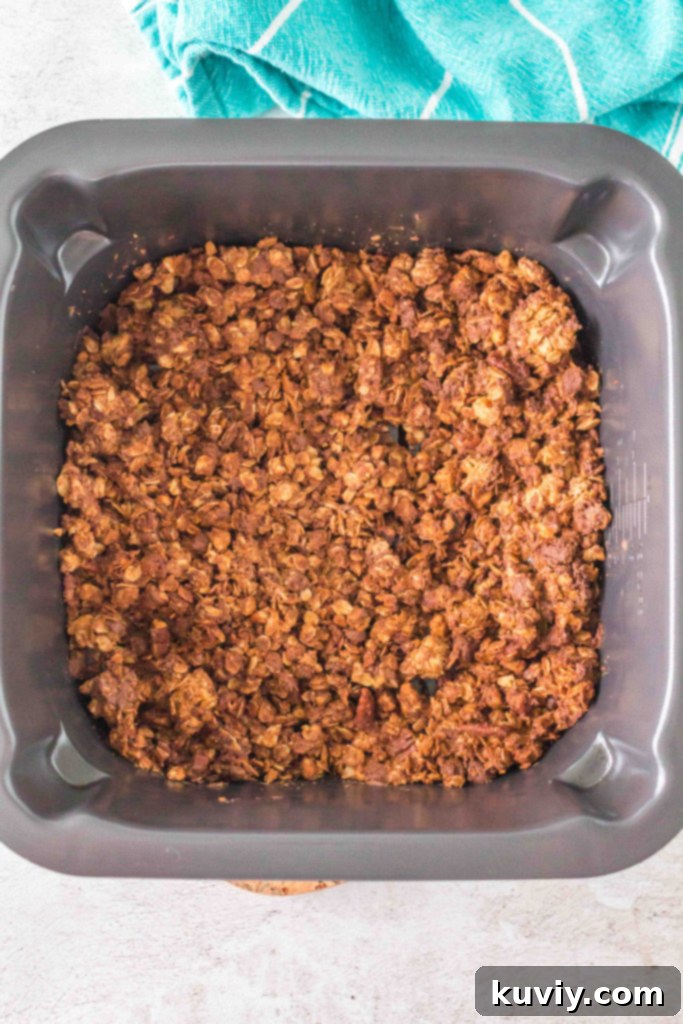 Air fryer basket filled with granola mixture