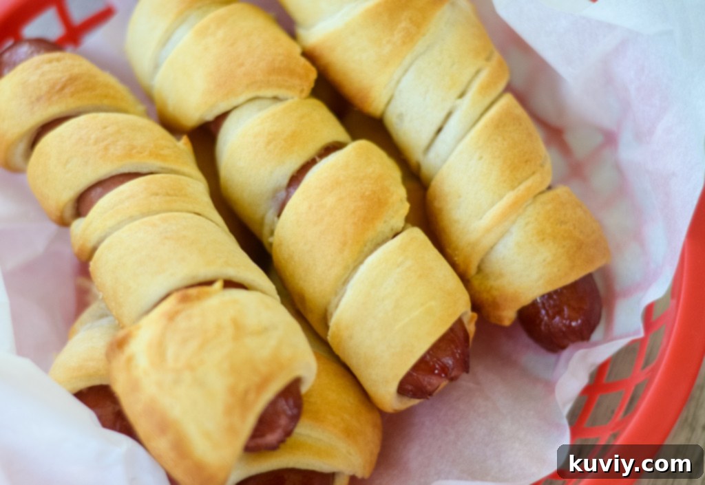 Crispy Air Fryer Crescent Hot Dogs 5 Air fryer basket with crescent hot dogs, sprayed with oil