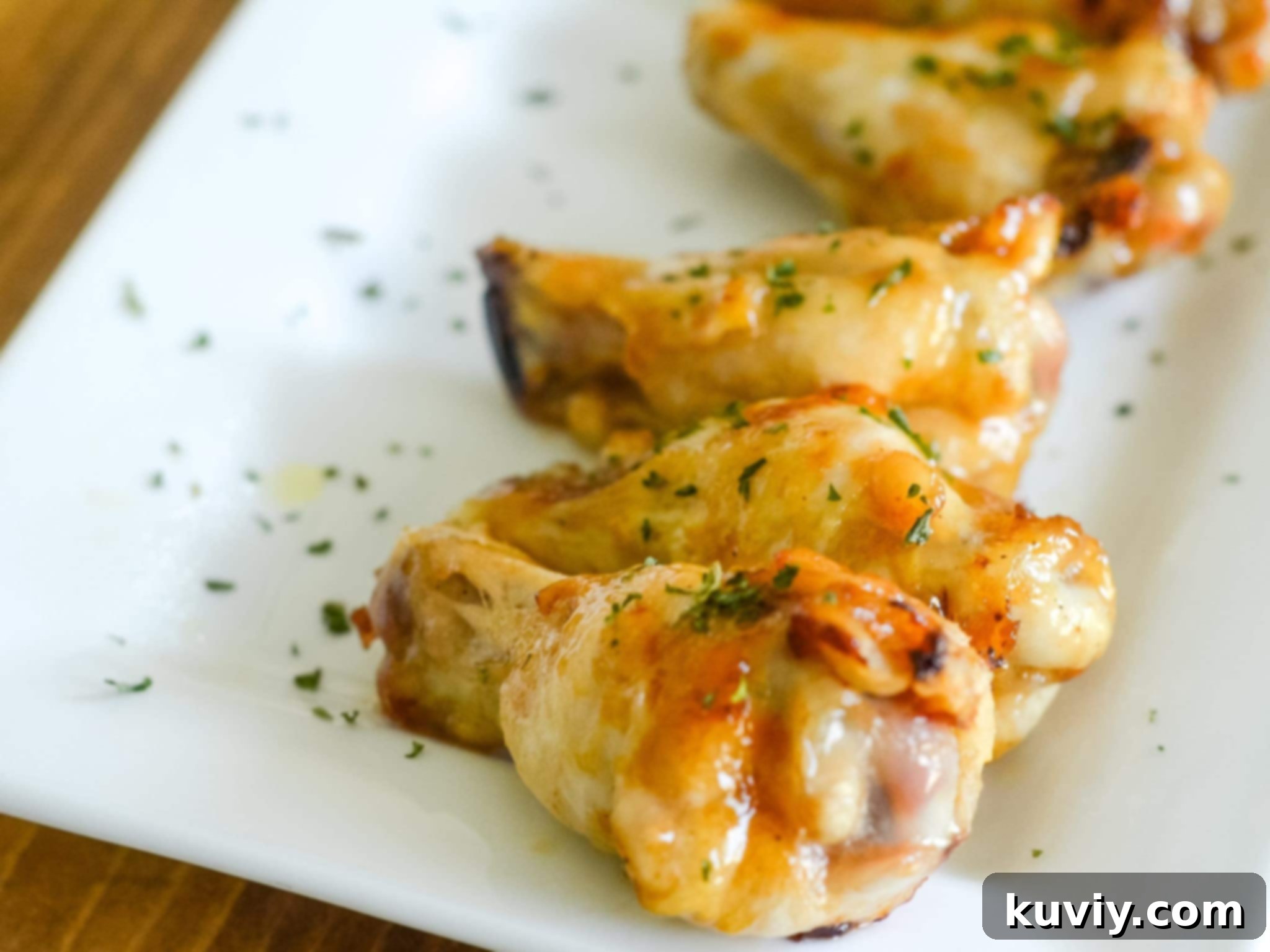 Air fryer basket lined with aluminum foil, ready for chicken wings.