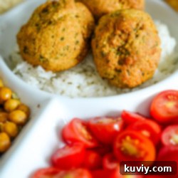 Air Fryer Falafel served on a platter with hummus, tomatoes, and rice.