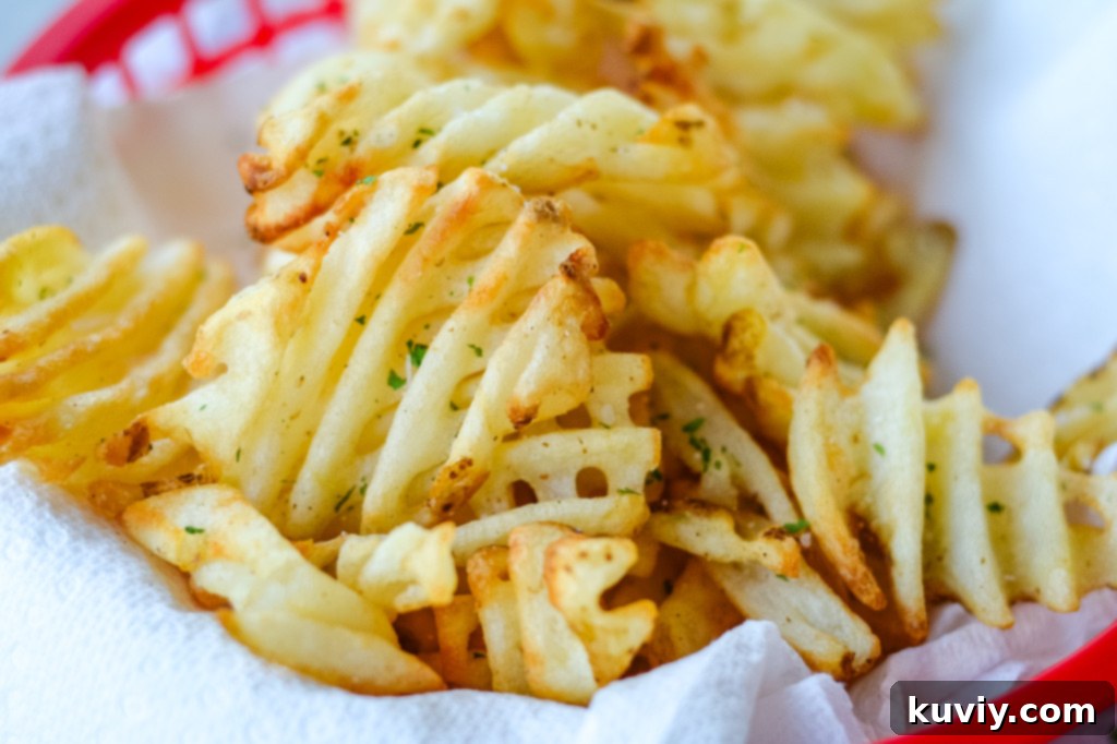 Close-up of golden air fryer waffle fries ready to serve