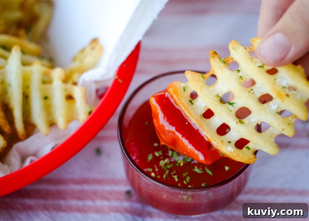 Assortment of different air fryer french fries, including waffle fries