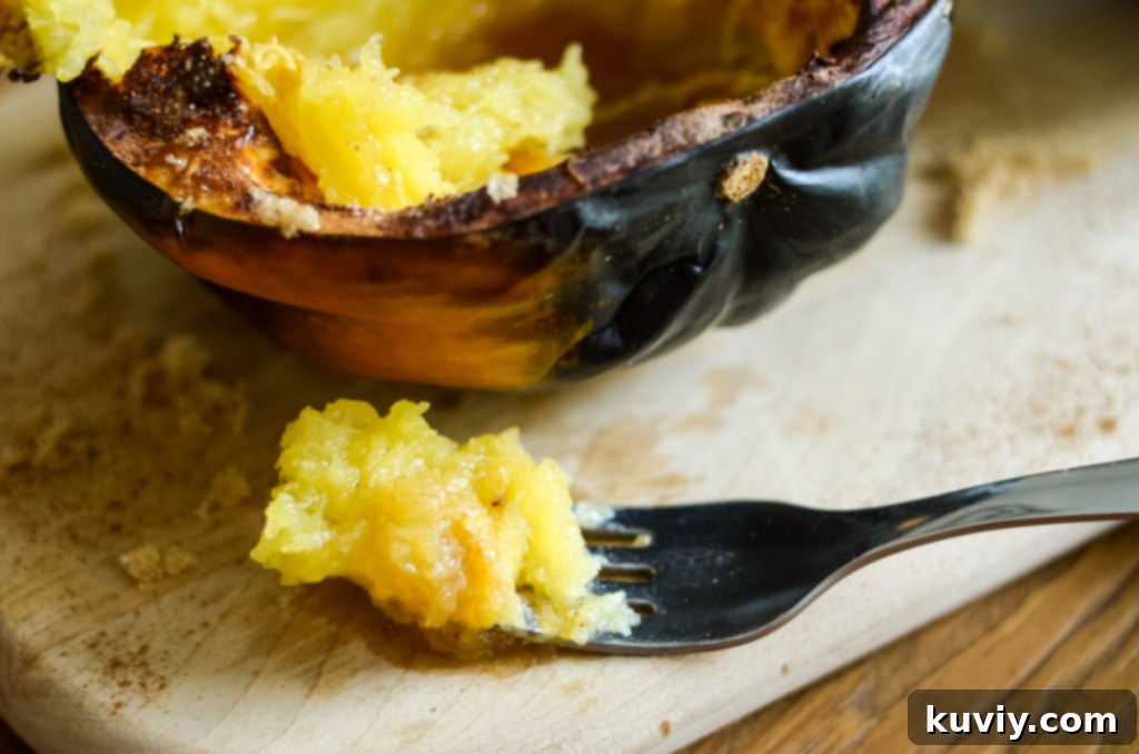 Air fryer acorn squash ready to be served, garnished with cinnamon and maple syrup